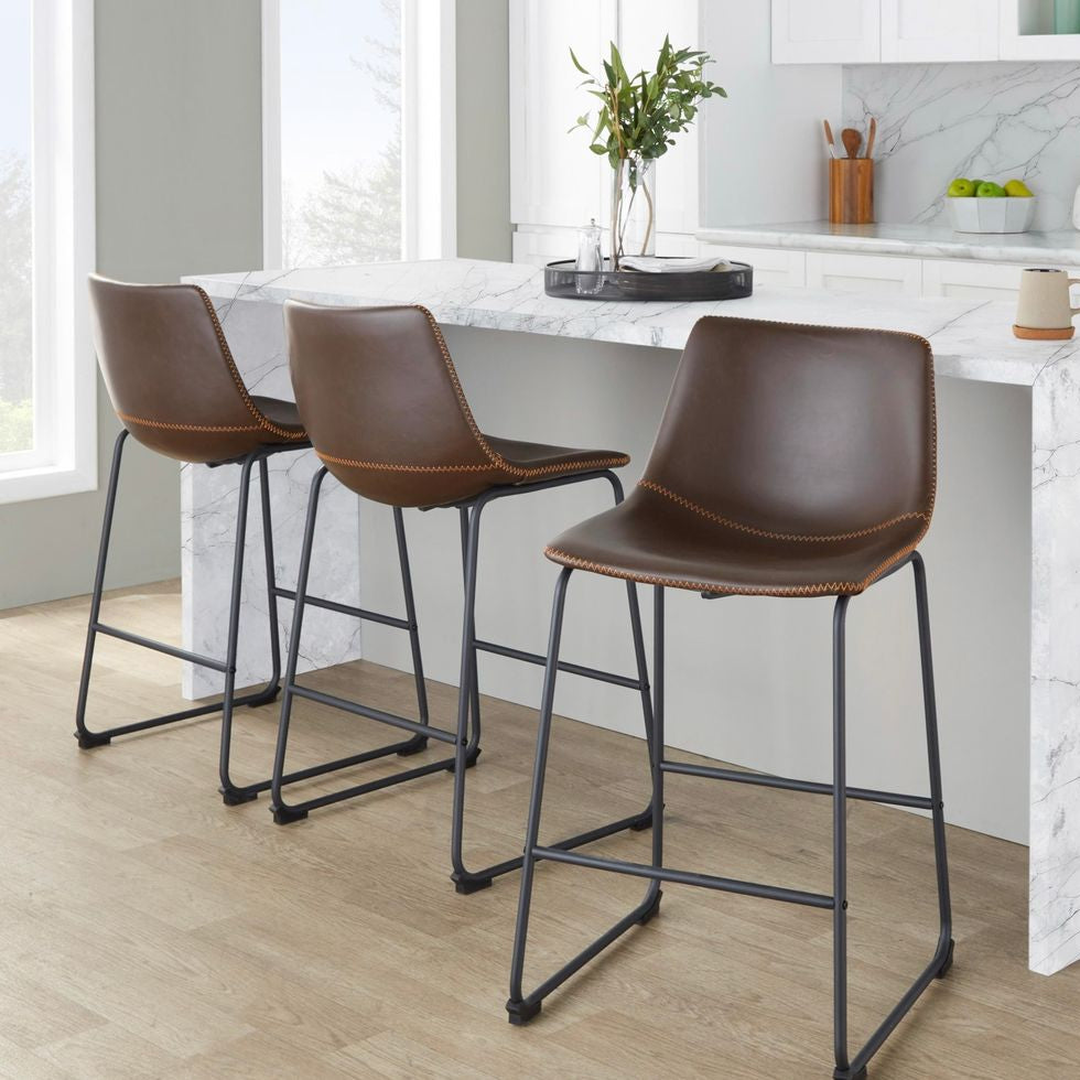 Three brown bar stools with black legs in a kitchen setting.